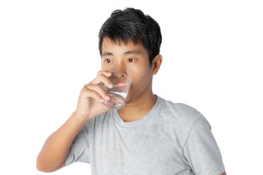 Beyaz arka planda izole edilmiş su içen genç bir adamın portresi.