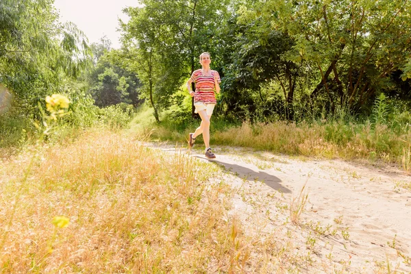 Senior Woman Running in the Forest — Stock Photo, Image