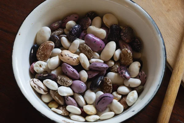 Multicolored Beans Enamel Cup Put Wooden Table — Stock Photo, Image