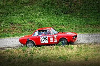 Unidentified drivers on a vintage Lancia Fulvia racing car