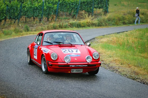 Unidentified drivers on a red vintage Porsche 911 S racing car — Stock Photo, Image