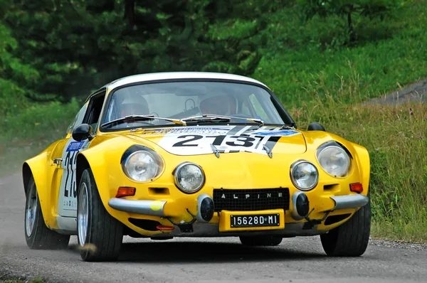 Unidentified drivers on a yellow vintage Alpine Renault racing car — стокове фото