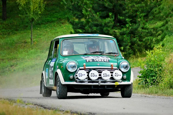 Unidentified drivers on a green vintage Mini Innocenti racing car — 스톡 사진