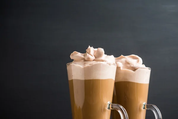 Coffee in glass on the dark wooden table — Stock Photo, Image