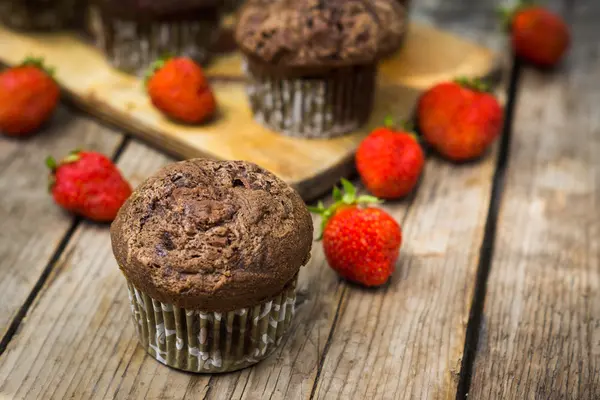 Chocolate muffins on the wooden background — Stock Photo, Image