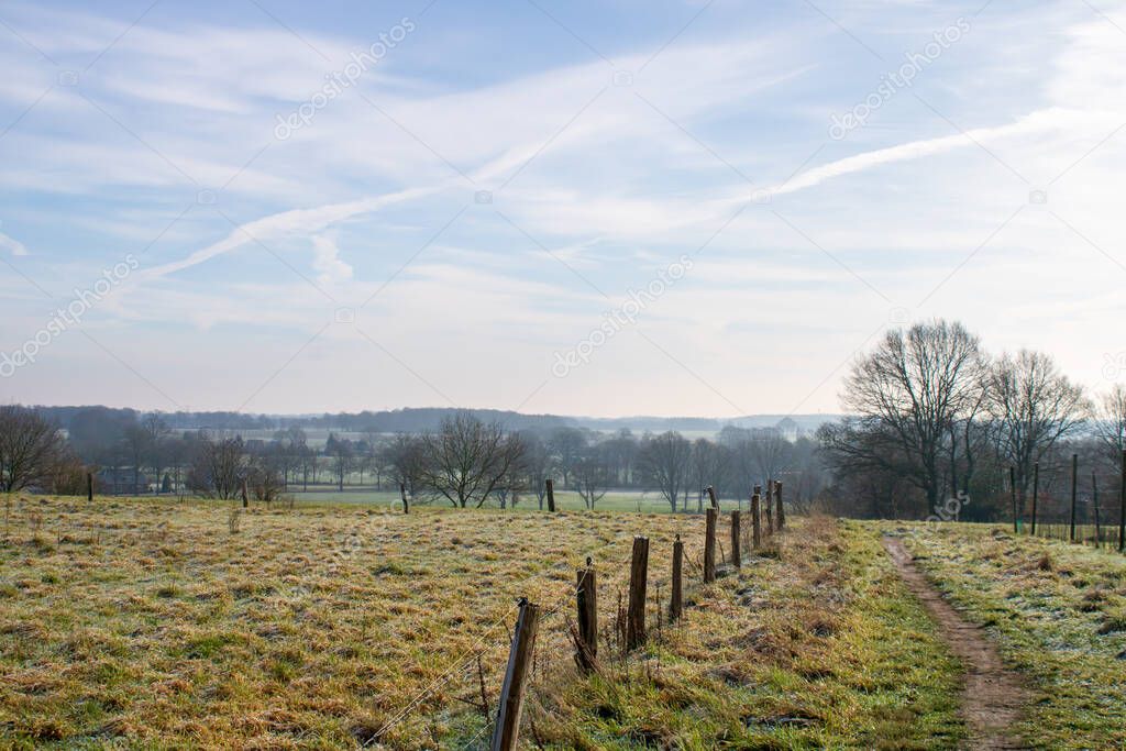 Hilltop view on Dutch town of Markelo at a cold winter morning. Hiking trail.
