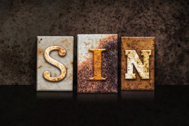 Günah Letterpress kavramı koyu arka plan üzerinde