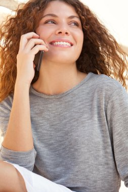 Akıllı telefon kullanan genç bir kadın.