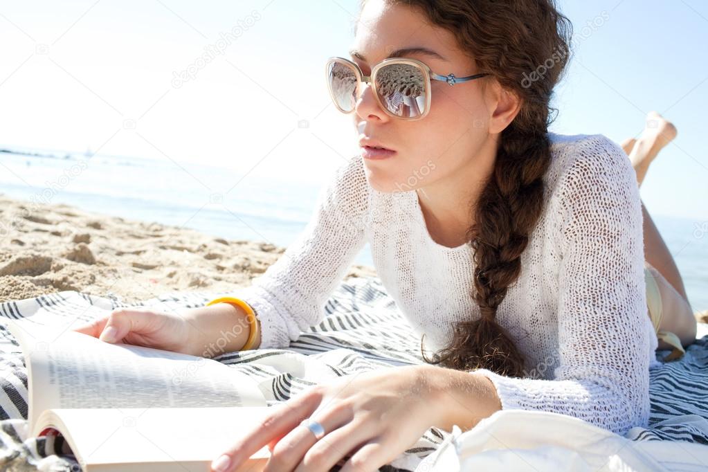 woman  reading a book at beach