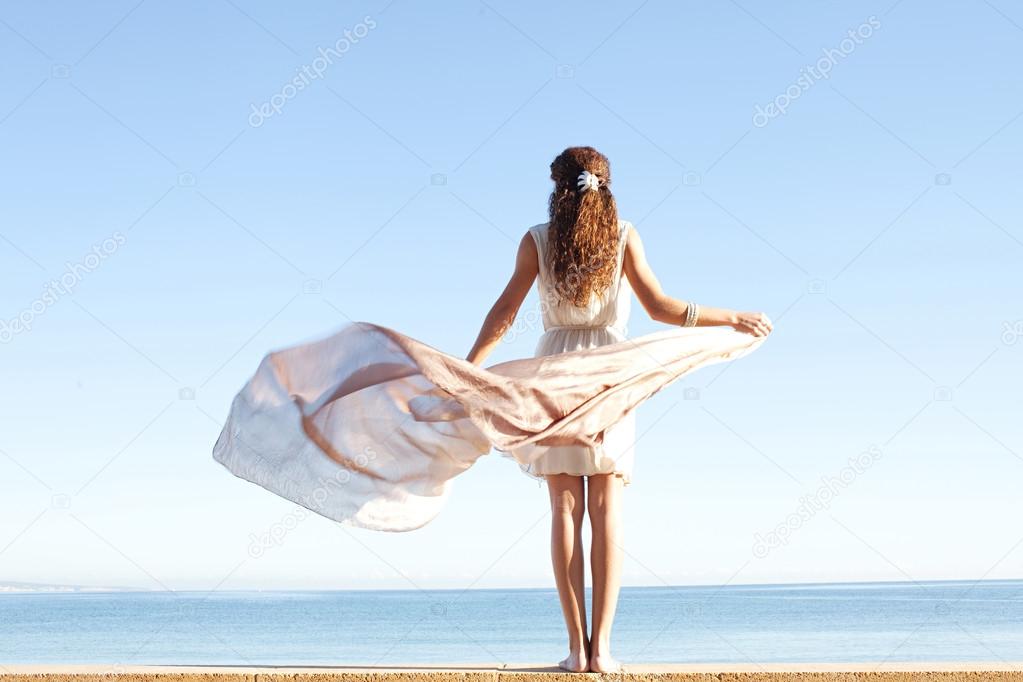 Woman in white against sky and sea