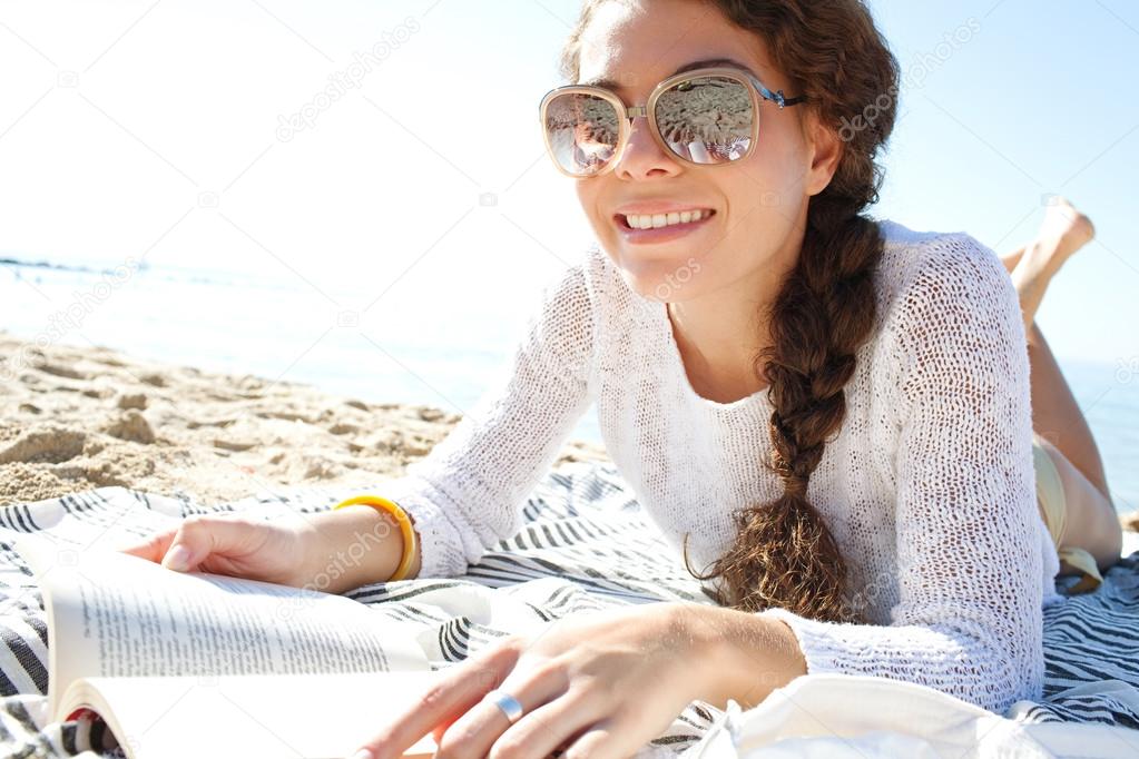 woman  reading a book at beach