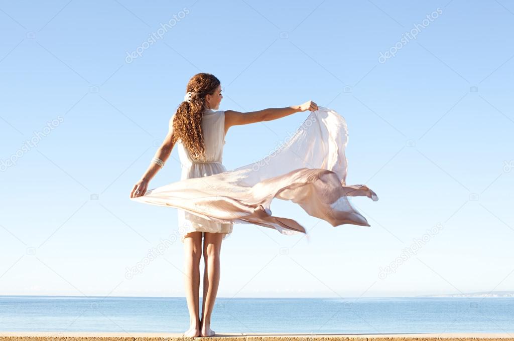 Woman in white against sky and sea