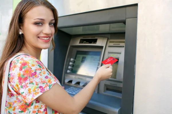 Woman using a cash point machine — 图库照片