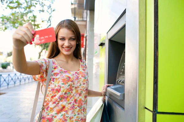 Woman using a cash point machine — Stok fotoğraf