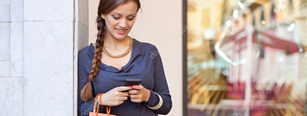 woman with shopping bags and phone