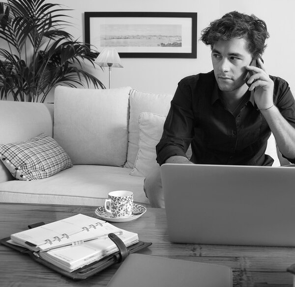Businessman with laptop working at home