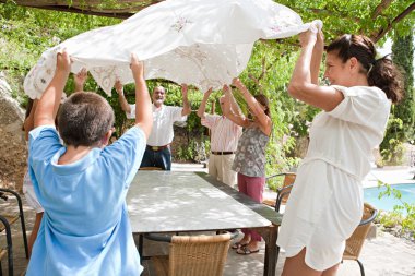 family getting ready for eating lunch outdoors