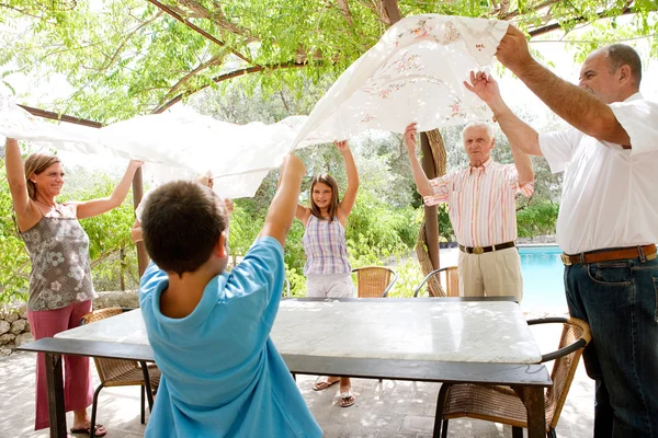 Family getting ready for eating lunch outdoors — 图库照片