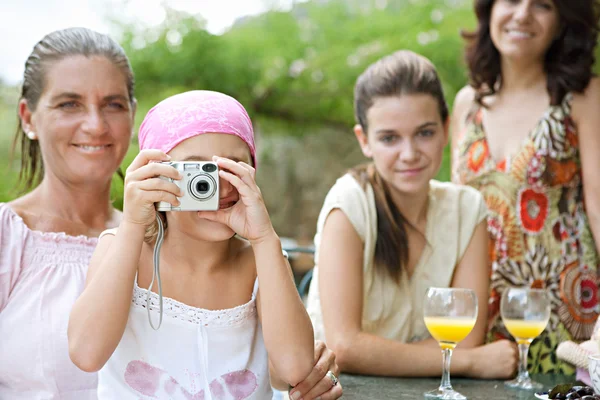 Family relaxing with a camera — Stock fotografie
