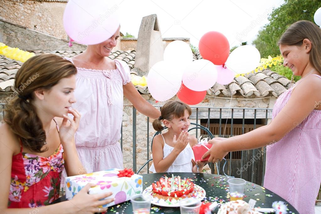 family celebrating a girl child birthday