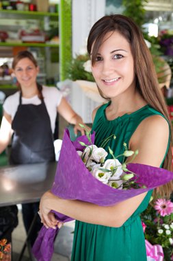 woman buys a bouquet of flowers