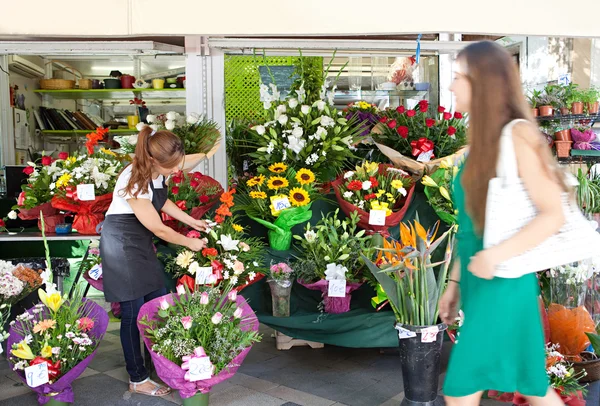 Florist woman works in her store — 스톡 사진