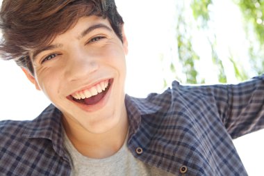 portrait of a teenager boy joyfully smiling