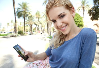 woman using a touch screen smartphone