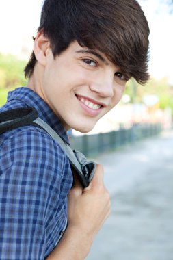 student boy walking at a college campus