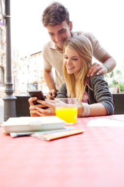 couple using a smartphoneat a cafe