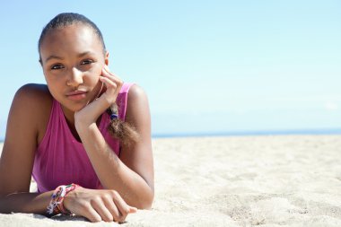 young woman relaxing on a sand beach