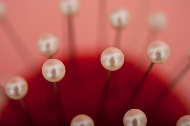 tailor pin cushion with multiple pins and needles pinned