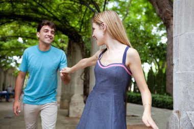 couple visiting a green park garden