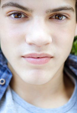 boy being thoughtful and looking at the camera