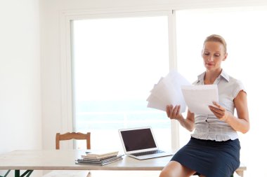 business woman holding and reading paperwork