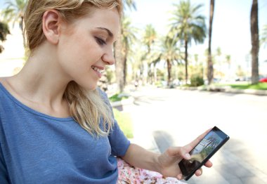 woman using a touch screen smartphone