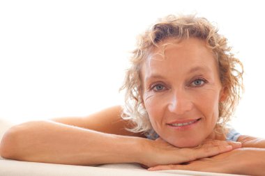 woman relaxing on a white sofa at home