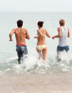 friends running together into the sea clipart
