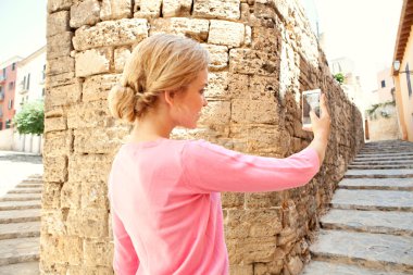 woman take pictures in the old city