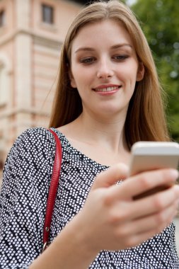 business woman holding and using a smartphone