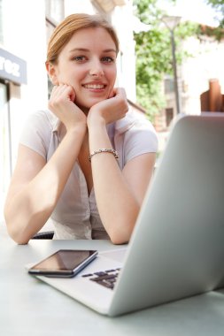 business woman at a cafe using a laptop computer