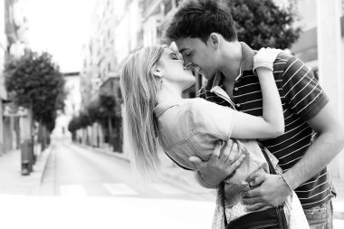 couple kissing and embracing while shopping