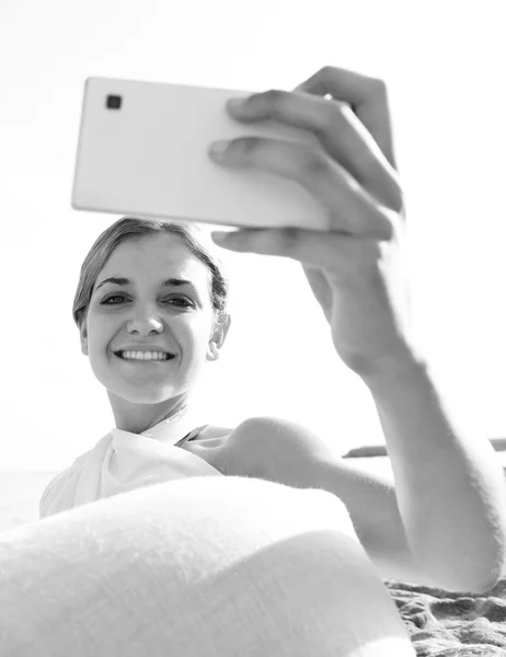 Vrouw met smartphone op het strand — Stockfoto