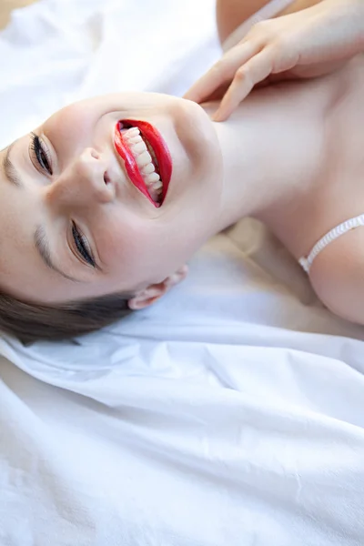 Sexy girl laying on a bed — Stok fotoğraf