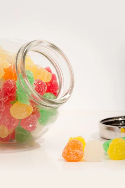 Glass jar container with candy sweets and jelly beans — Stok fotoğraf