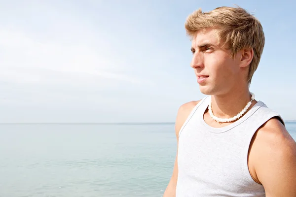 Portrait of an attractive teenager boy on a beach — Stok fotoğraf