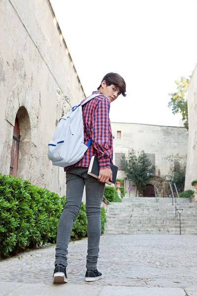 Student boy walking up the stairs in a college campus — Stockfoto