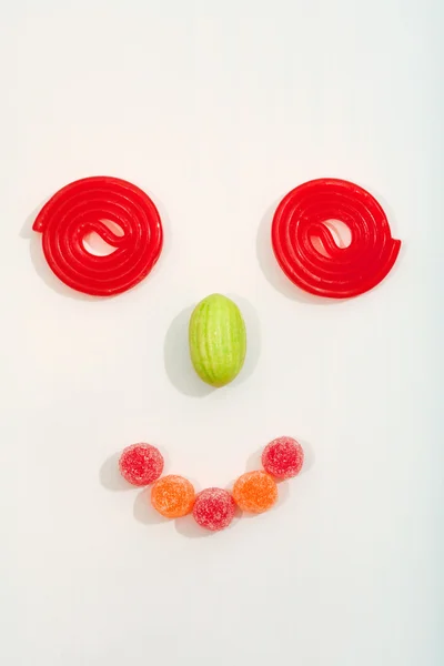 Person face made of a variety of sugar candy sweets and liquorice — Stock Photo, Image