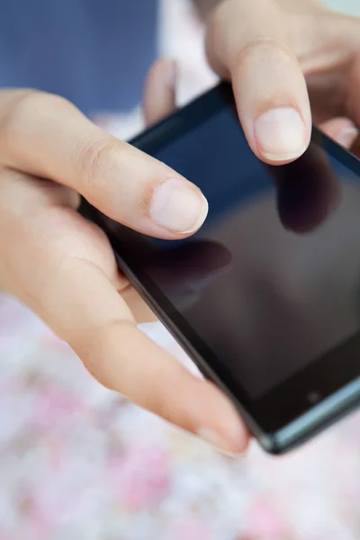 Woman using a touch screen smartphone — Stok fotoğraf