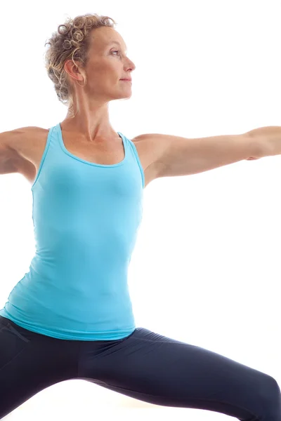 Женщина, использующая коврик для йоги для упражнений — стоковое фото